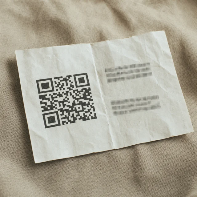 A printed paper wallet with a QR code and address fields